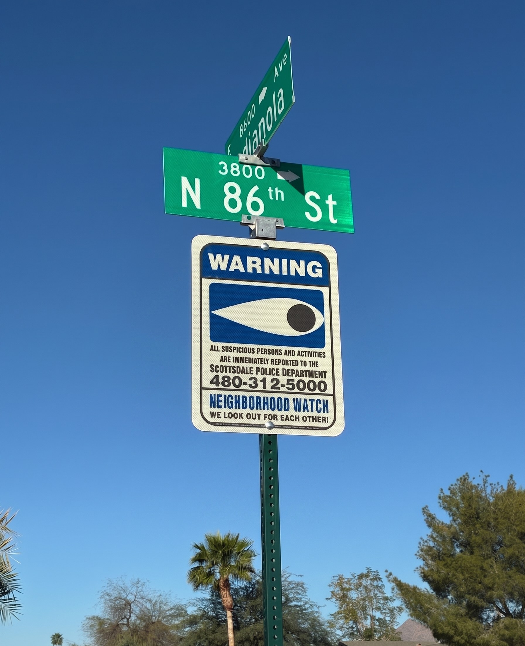 NNWI Blue Eye reflective Neighborhood Watch warning sign installed at a Scottsdale, Arizona neighborhood intersection